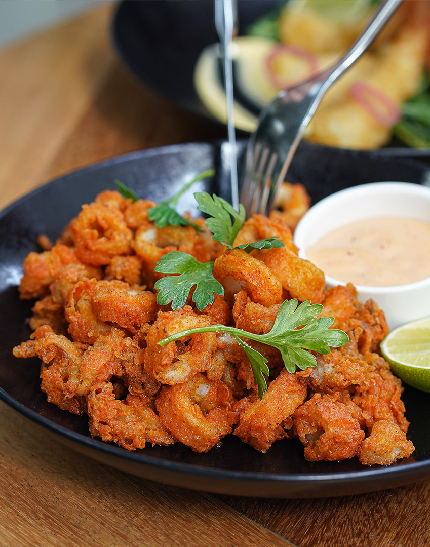 Tempura prawns dish with a side of chilli mayo sauce.