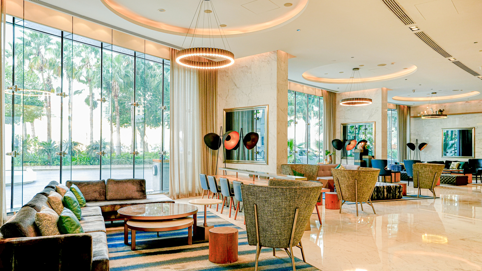 Media One Hotel lobby showcasing comfortable chairs situated next to a large window with natural light.